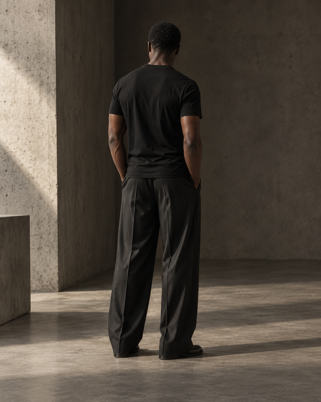Model wearing the black SpyceTEEs Essential T-shirt with wide-leg tailoring