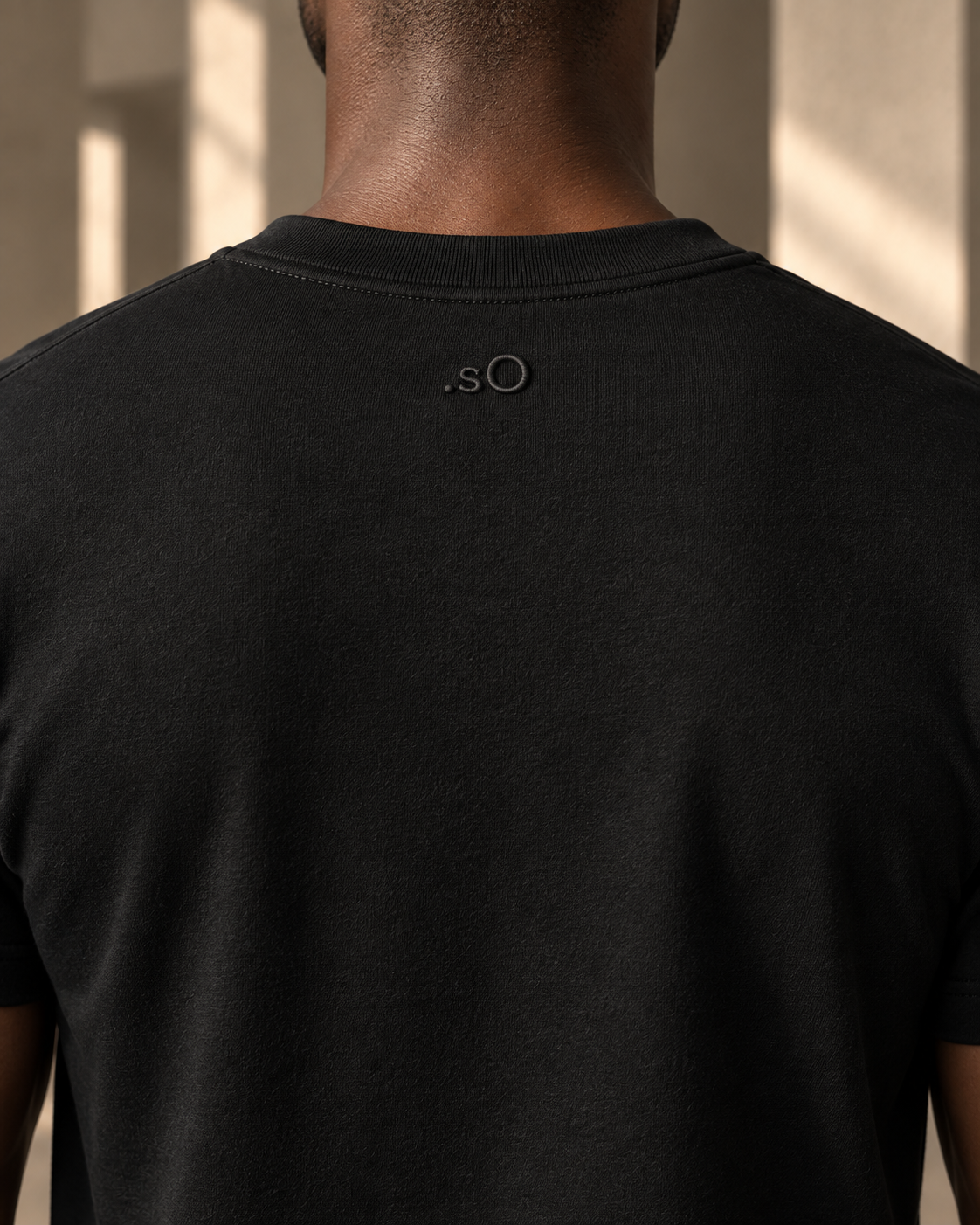 Raised tonal .sO embroidery at the back neck